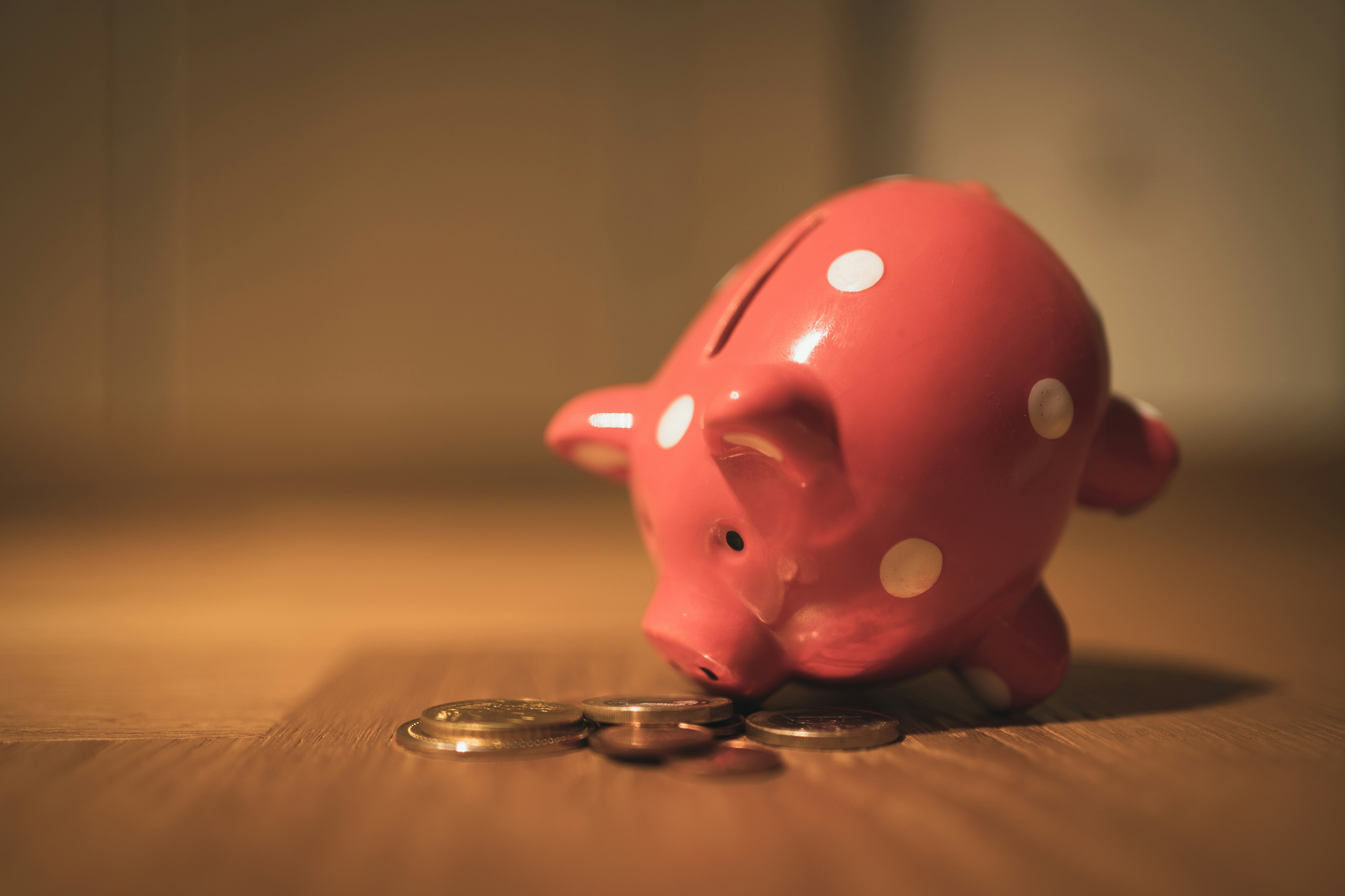 A piggy bank with coins — your KiwiSaver savings going toward a first home deposit