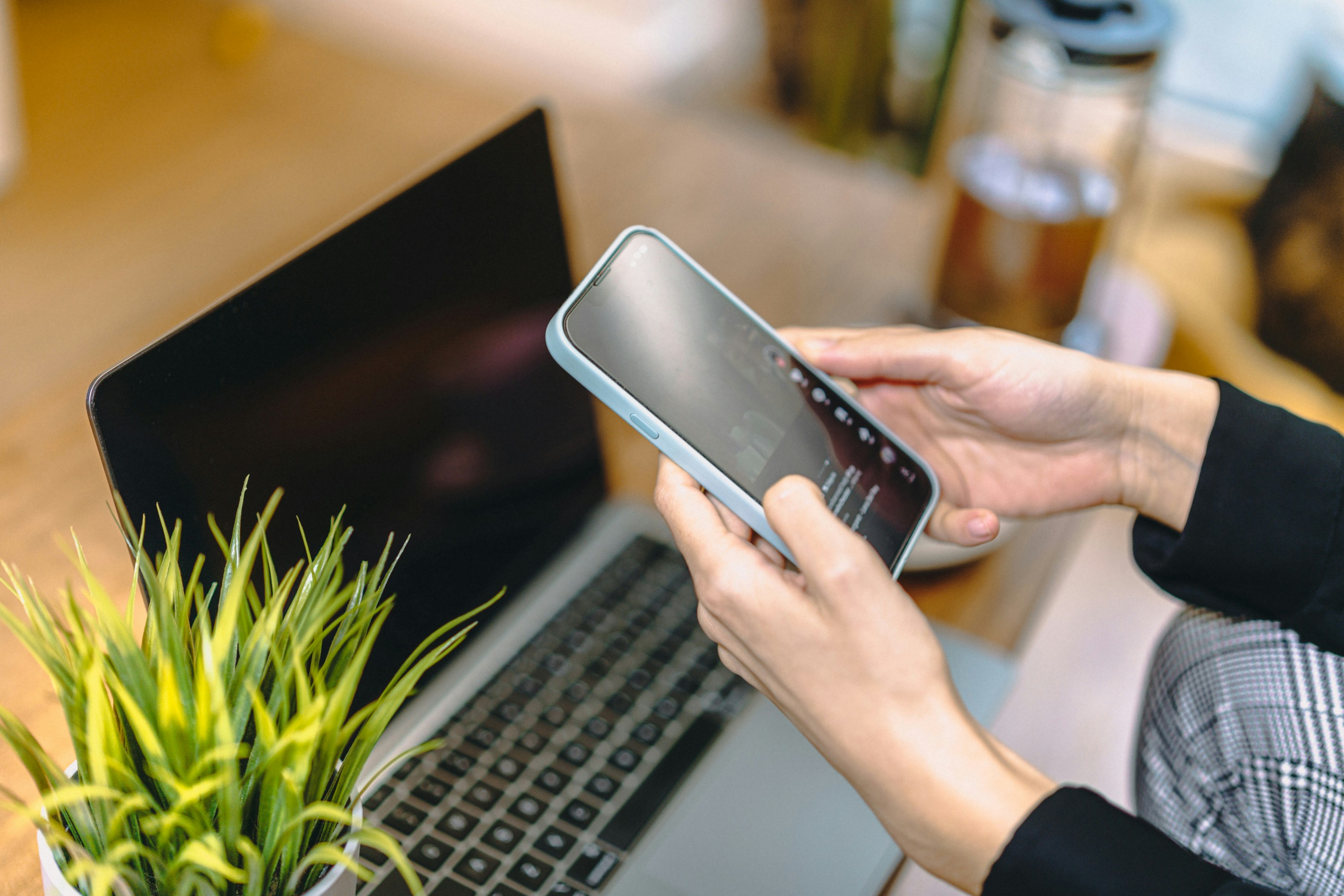 Searching for an investment property on a phone and laptop